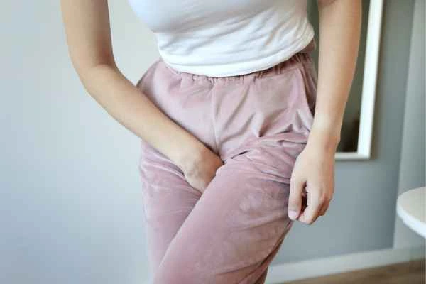 older woman running to the toilet because of urinary incontinence Greater London (Tower Hamlets)